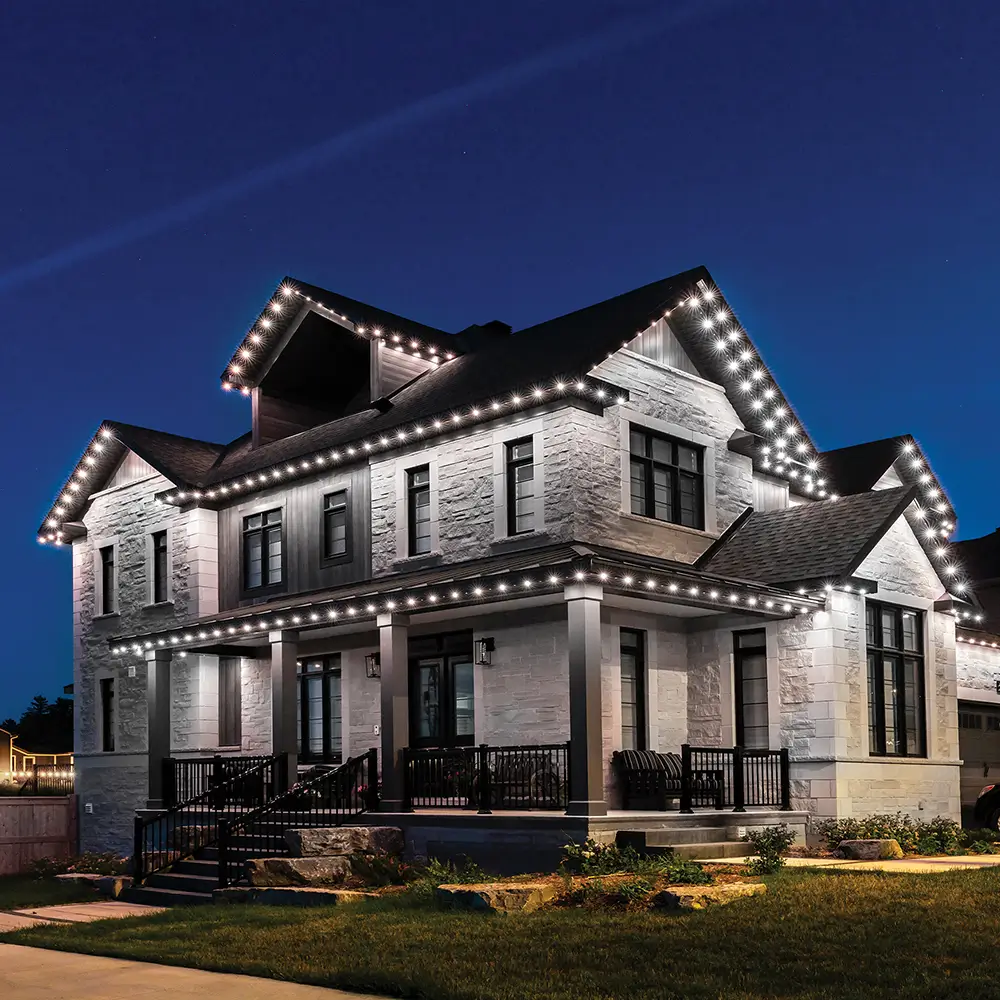 Elegant white home with permanent LED accent lighting highlighting architecture