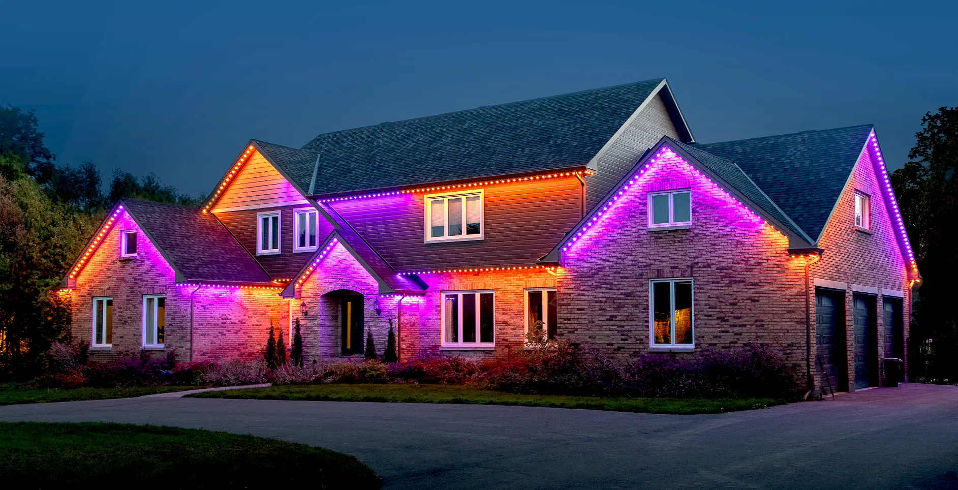Stunning brick home with vibrant multi-color LED accent lighting