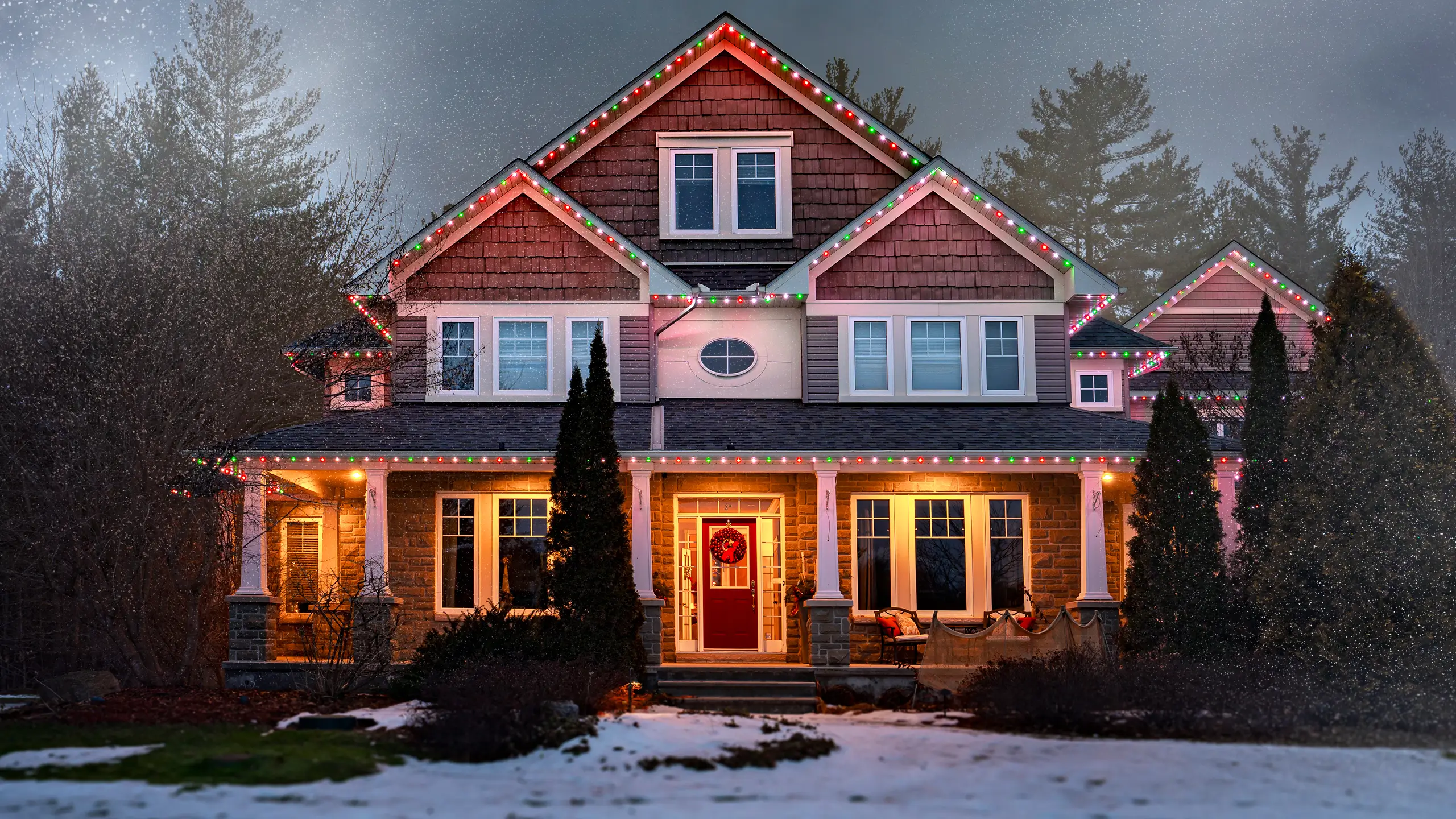 Traditional home decorated with festive red and green Christmas lights